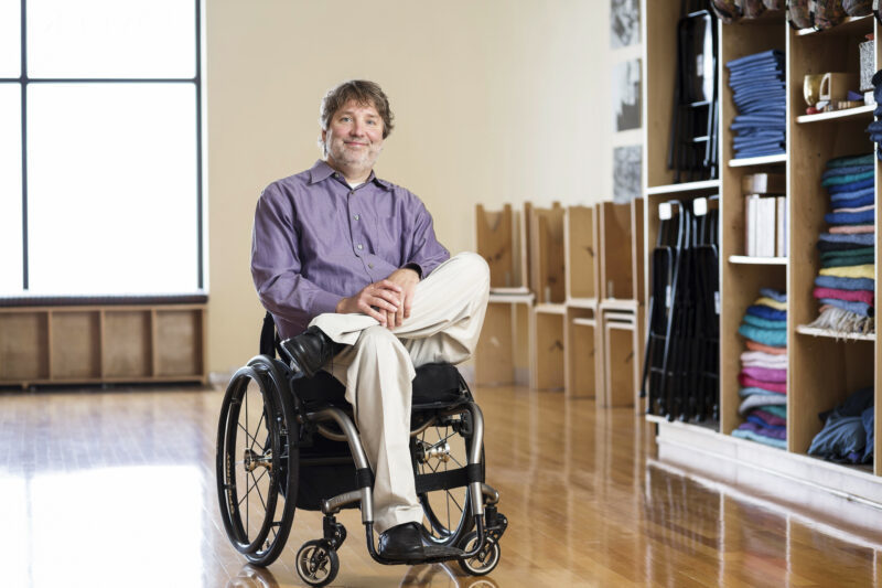 child blowing dandilions